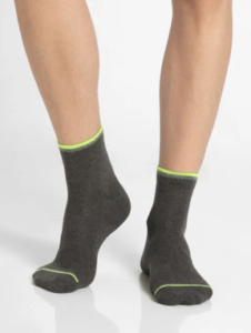 Man wearing charcoal grey cotton ankle socks with neon green trim